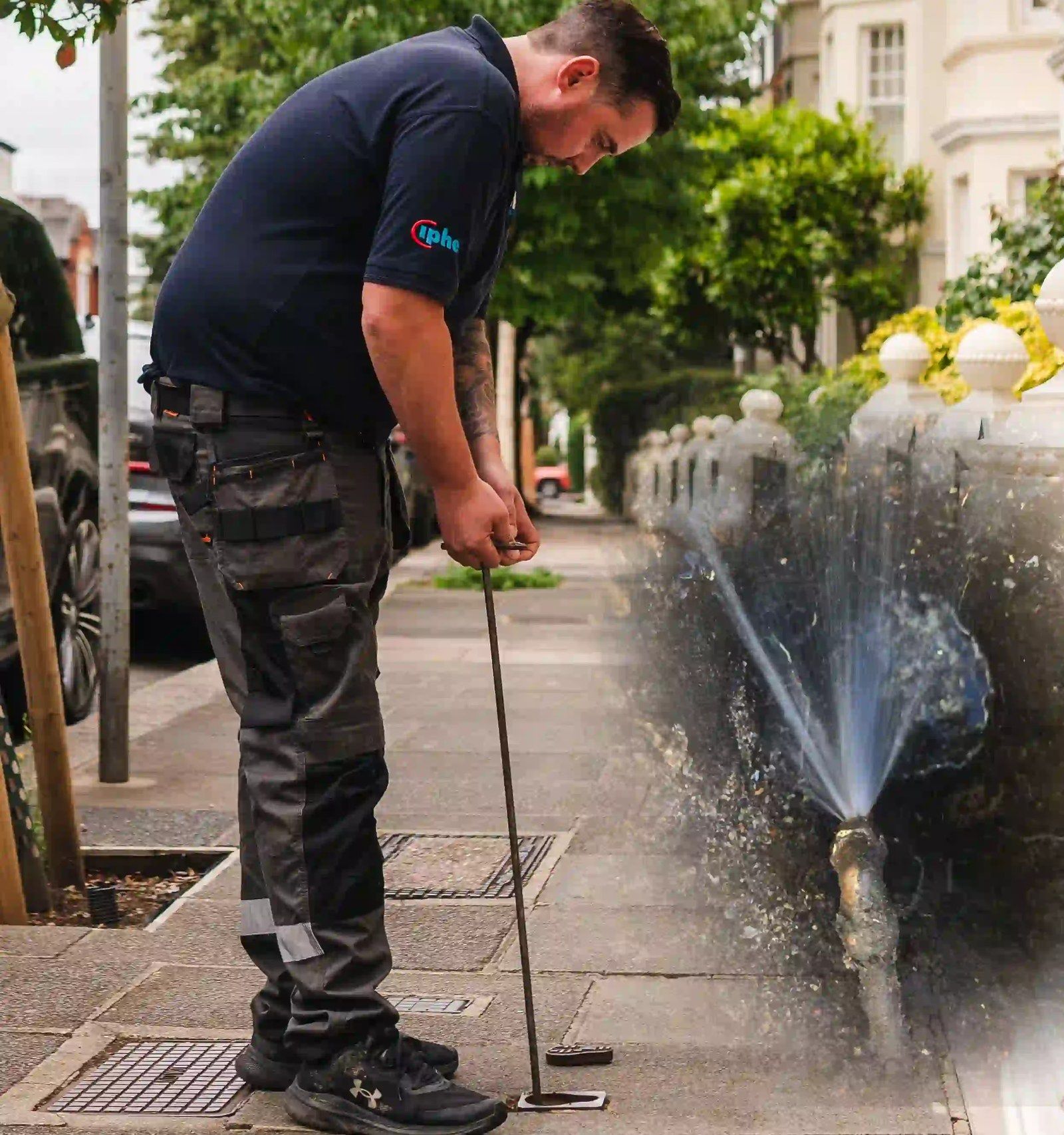 An engineer on a pavement listening to the ground with an acoustic probe